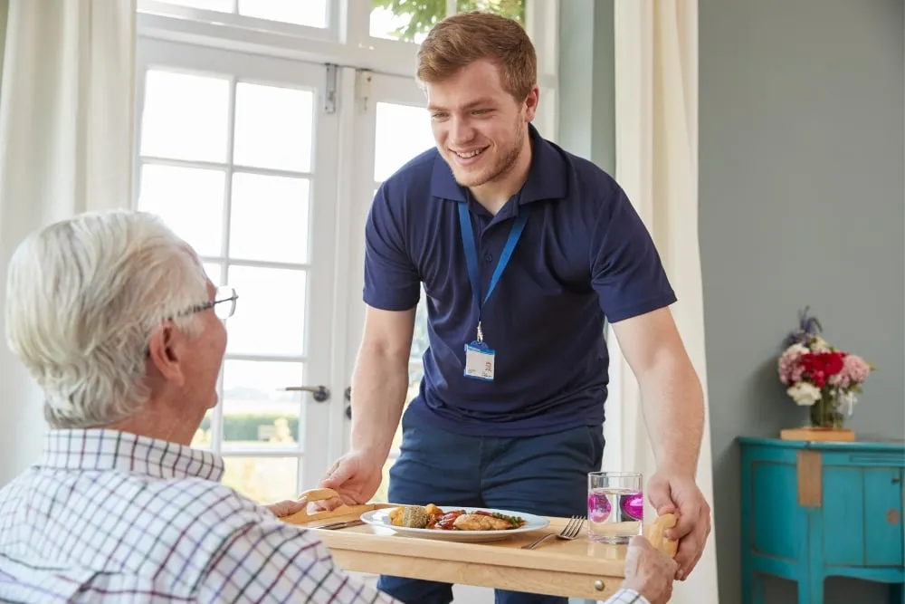 Support worker assisting person with disability at home