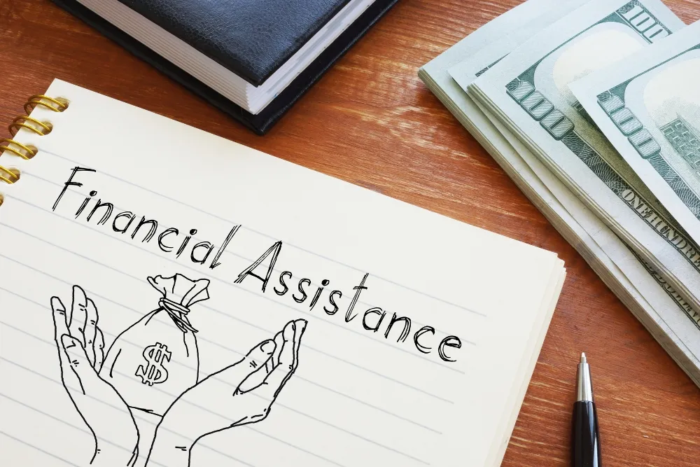 notebook with drawing and pen and money on the table