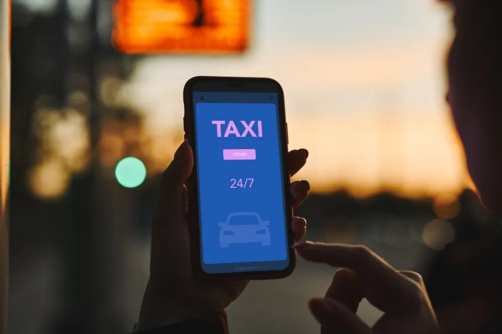 a person booking a taxi through a mobile application